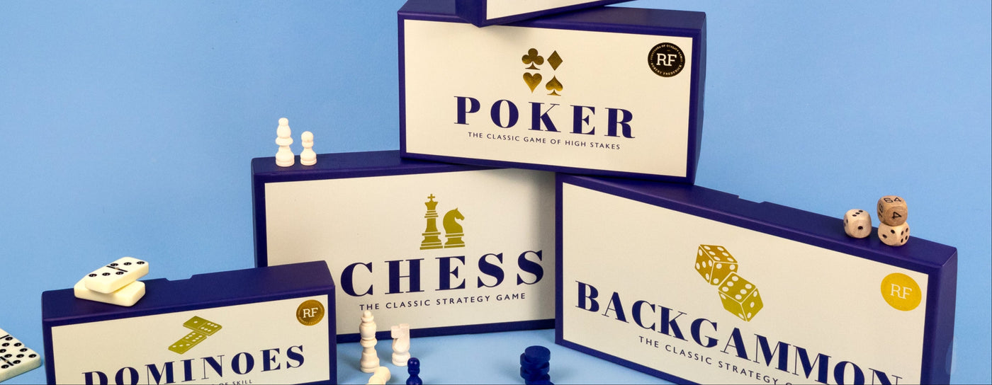 Collection of board game boxes including Yatzy, Poker, Chess, and Backgammon on a blue background.